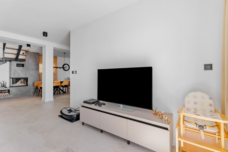 Area for children with a sofa, flat-screen TV, PlayStation 4, and many other toys