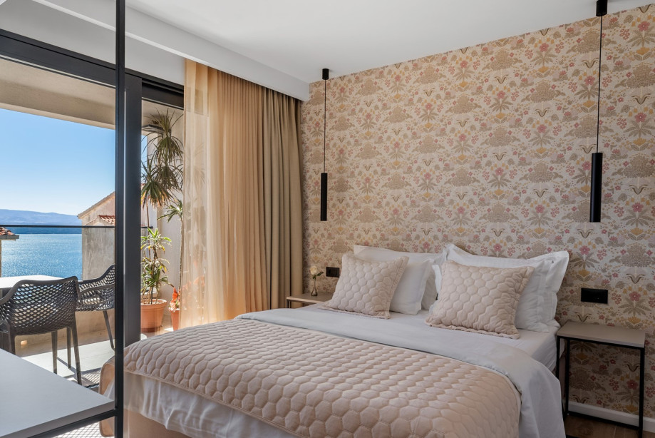 Bedroom NO2 is equipped with a queen-sized bed, TV, AC, en-suite bathroom, and a shared terrace with sea views