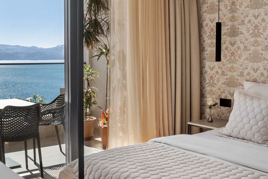 Bedroom NO2 is equipped with a queen-sized bed, TV, AC, en-suite bathroom, and a shared terrace with sea views