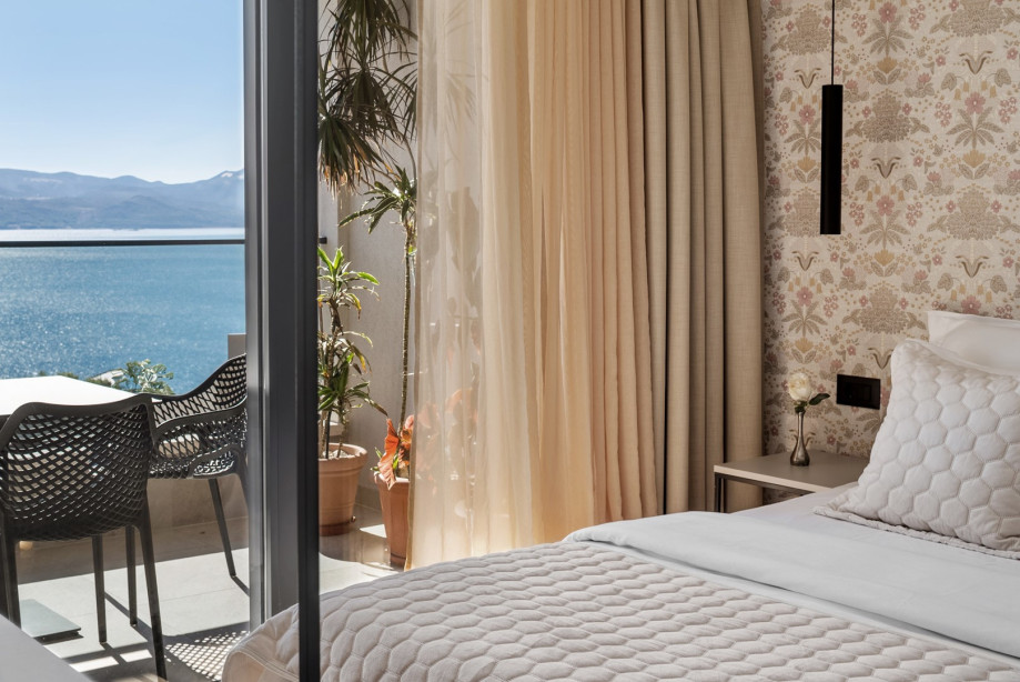 Bedroom NO2 is equipped with a queen-sized bed, TV, AC, en-suite bathroom, and a shared terrace with sea views