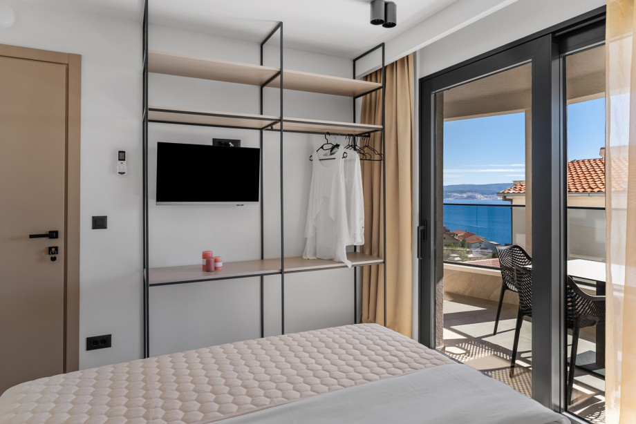 Bedroom NO2 is equipped with a queen-sized bed, TV, AC, en-suite bathroom, and a shared terrace with sea views