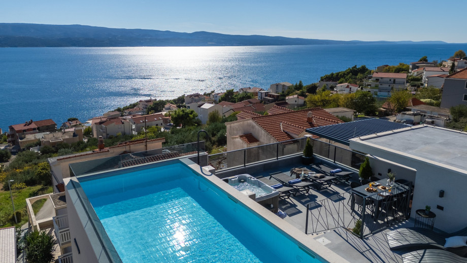 The rooftop is approached by an indoor staircase from the living area