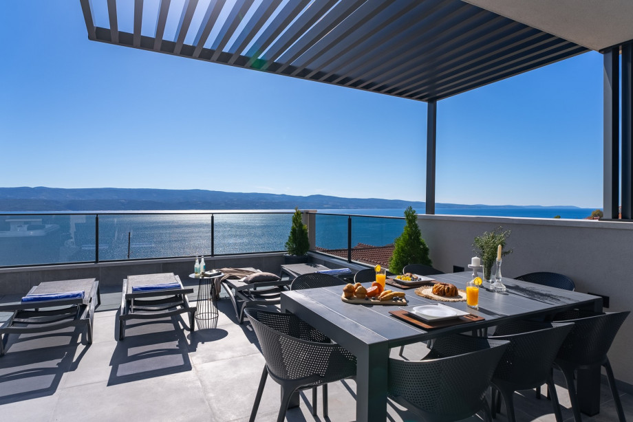 Outdoor dining area, kitchenette, and electric grill