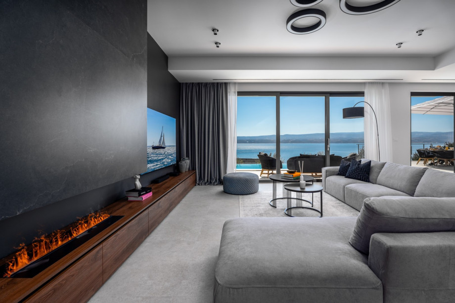 Modern furnished living area with exit to the pool.