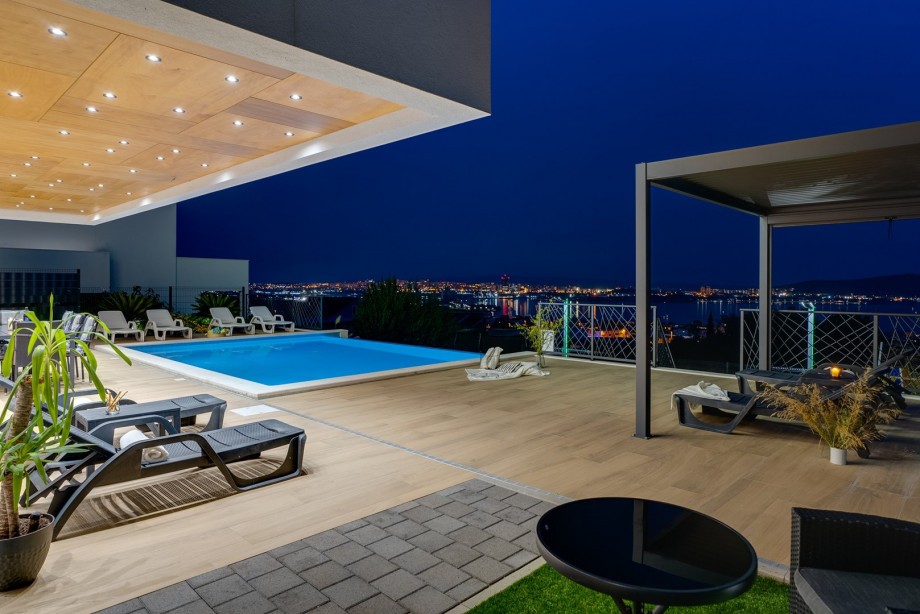 Outdoor area with heated pool and large sunbathing area