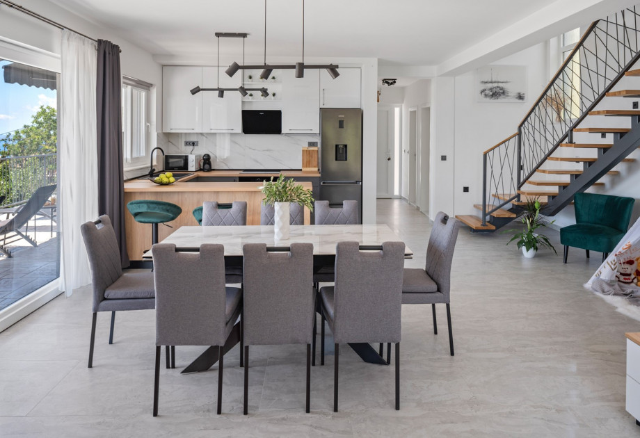 The ground floor features a stylish living and dining area with air conditioning