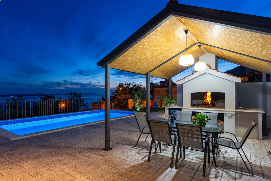 Outdoor dining area with barbecue is the best place for a family gathering