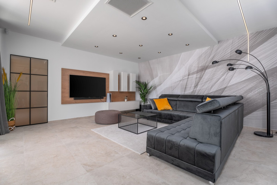 Very comfortable living room (32sqm) with sofas, flat screen TV, PS5, Bluetooth speaker system, all fully air-conditioned.