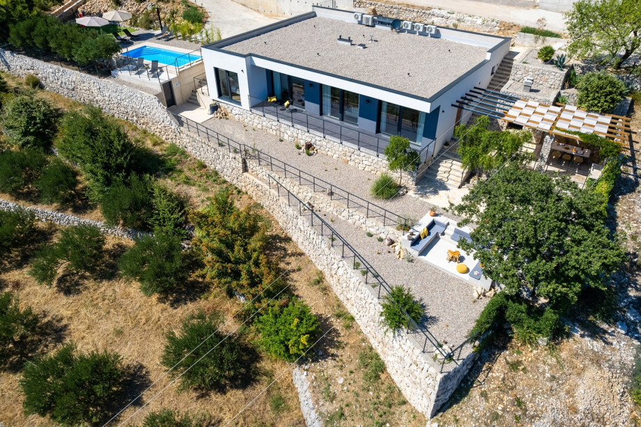 A fully air-conditioned 4-bedroom villa with free WiFi, spacious living area, fully equipped kitchen, a charming outdoor dining area and lounge corner,