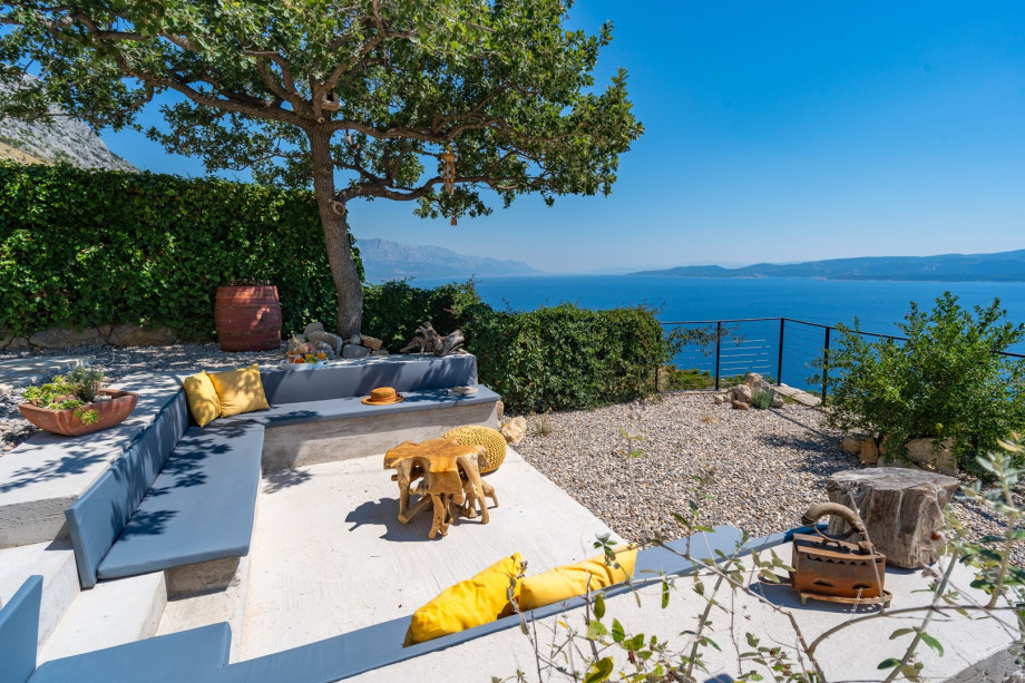 Lounge corner with an oak tree shade and spectacular sea views, which makes this a perfect spot for a glass of vine or a cup of coffee in the morning