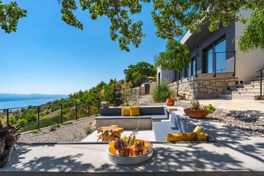 Lounge corner with an oak tree shade and spectacular sea views, which makes this a perfect spot for a glass of vine or a cup of coffee in the morning