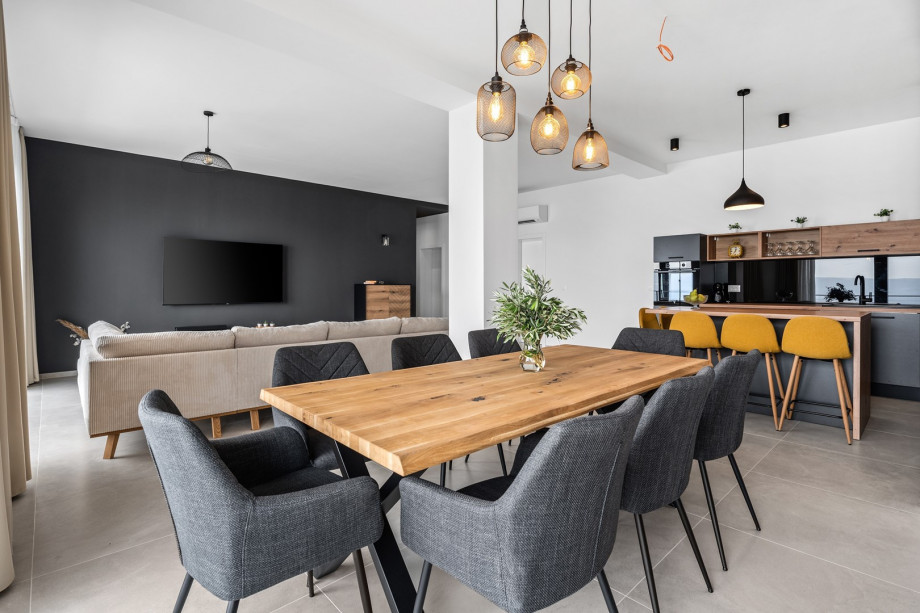 Spacious living/dining room with glass walls that give you a beautiful view of the sea and lots of daylight inside