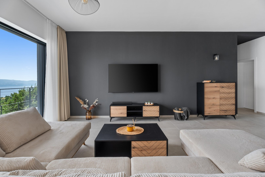 The living room with a very comfortable sofa, a flat screen TV, Netflix, Play Station 4.