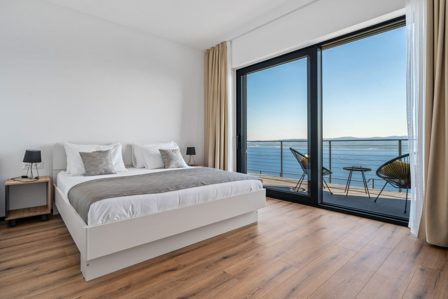 Bedroom NO1 (15sqm) with a king size bed 180cm x 200cm, TV, A/C, sea views, en-suite bathroom (5sqm) with a shower.