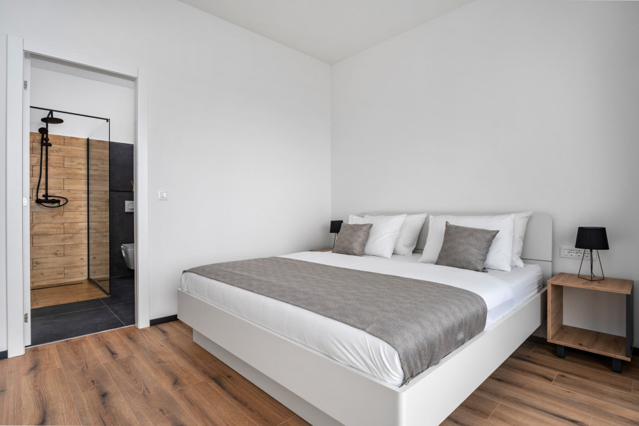 Bedroom NO1 (15sqm) with a king size bed 180cm x 200cm, TV, A/C, sea views, en-suite bathroom (5sqm) with a shower.