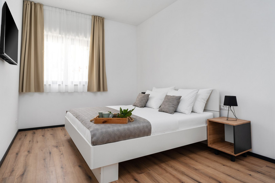 Bedroom NO4 (14,6sqm) with king size bed 180cm x 200cm, TV, A/C, views of the pool area on the west side.