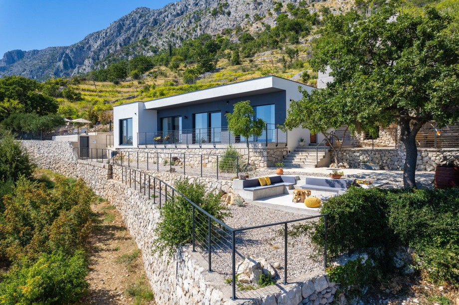 A fully air-conditioned 4-bedroom villa with free WiFi, spacious living area, fully equipped kitchen, a charming outdoor dining area and lounge corner,