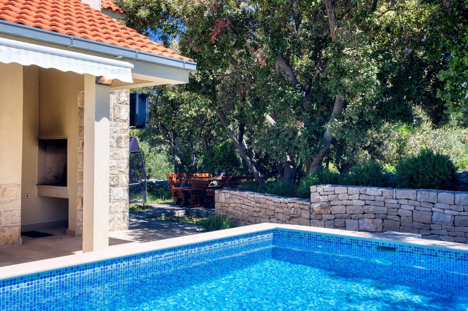 Outdoor dining area with a traditional barbecue