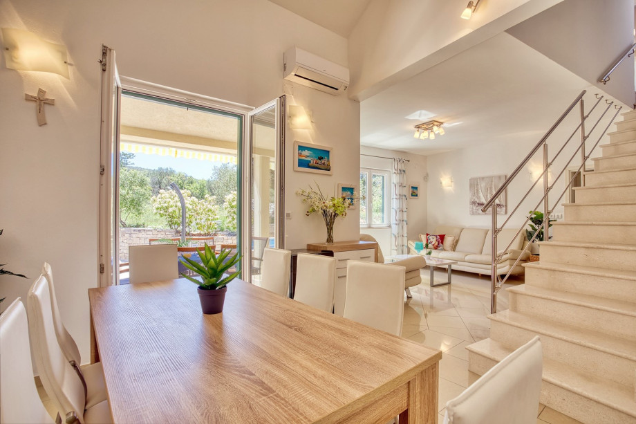 A dining table with a direct approach to the outdoor dining area