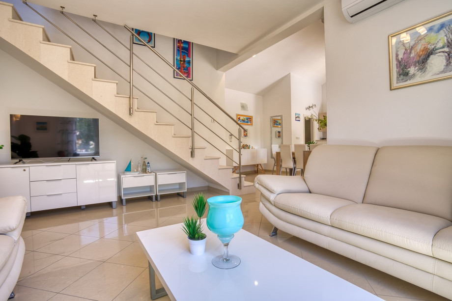 A living room offers a flat-screen TV and a PS4