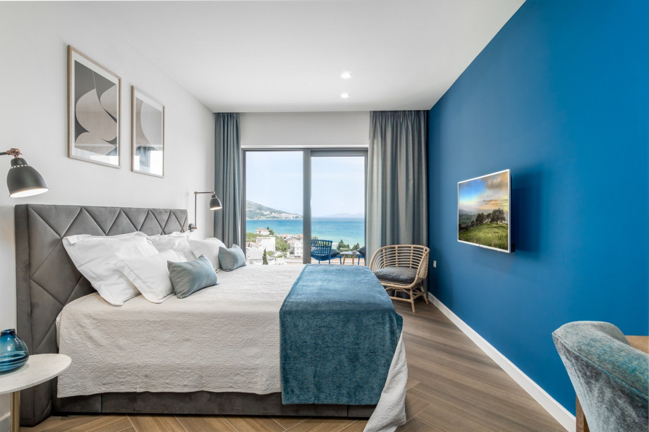 Bedroom No1 with a king-size bed 180x200cm, TV, A/C, en-suite bathroom with a shower, and a balcony