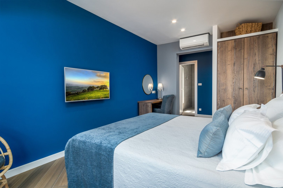 Bedroom No1 with a king-size bed 180x200cm, TV, A/C, en-suite bathroom with a shower, and a balcony