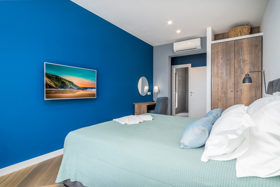 Bedroom No3 with a king-size bed 180x200cm, TV, A/C, en-suite bathroom with a shower, and a balcony