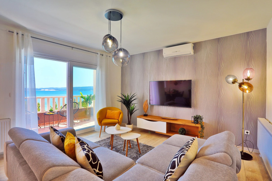 Modern living and dining area with exit to pool and sun deck area (1st floor)