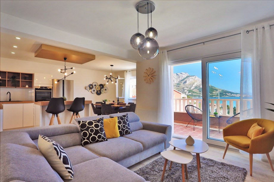 Modern living and dining area with exit to pool and sun deck area (1st floor)