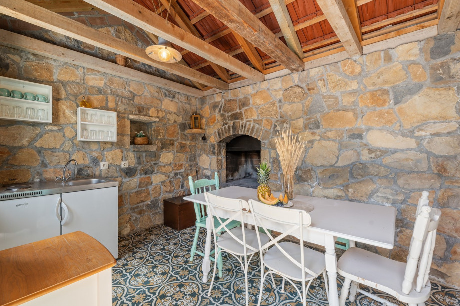 Summer kitchen with traditional grill next to the pool