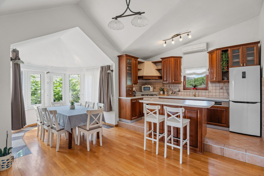 Fully equipped kitchen with romantic windows around the dining area, air-conditioned