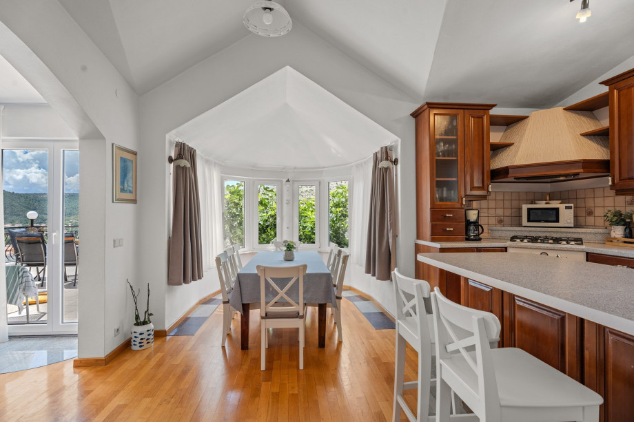 Fully equipped kitchen with romantic windows around the dining area, air-conditioned