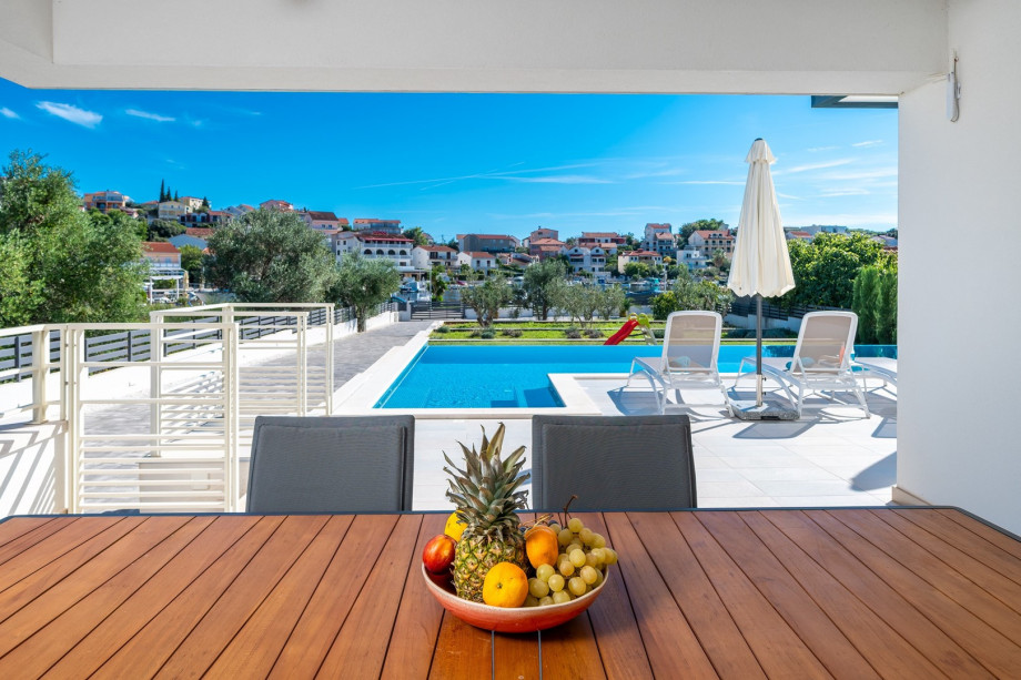 Covered terrace with a comfortable outdoor dining area and a stunning view