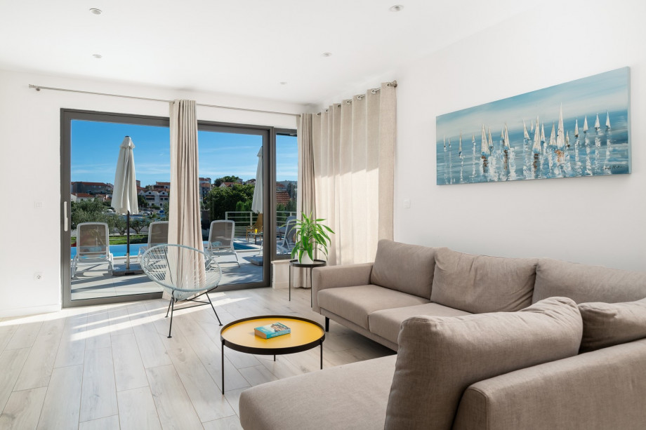 The ground floor offers a very bright living room due to the glass walls facing the pool