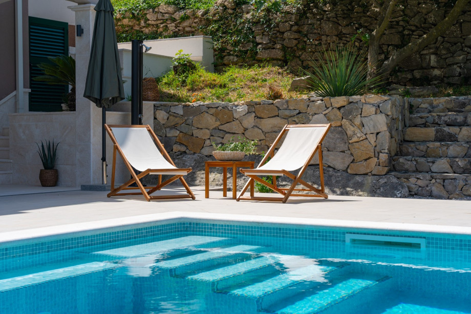 The pool area can be directly approached from the Kitchen and gym