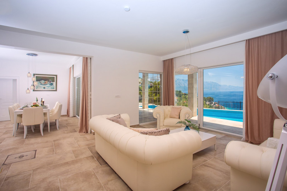 Spacious  living area with direct exit to the pool area and sea views