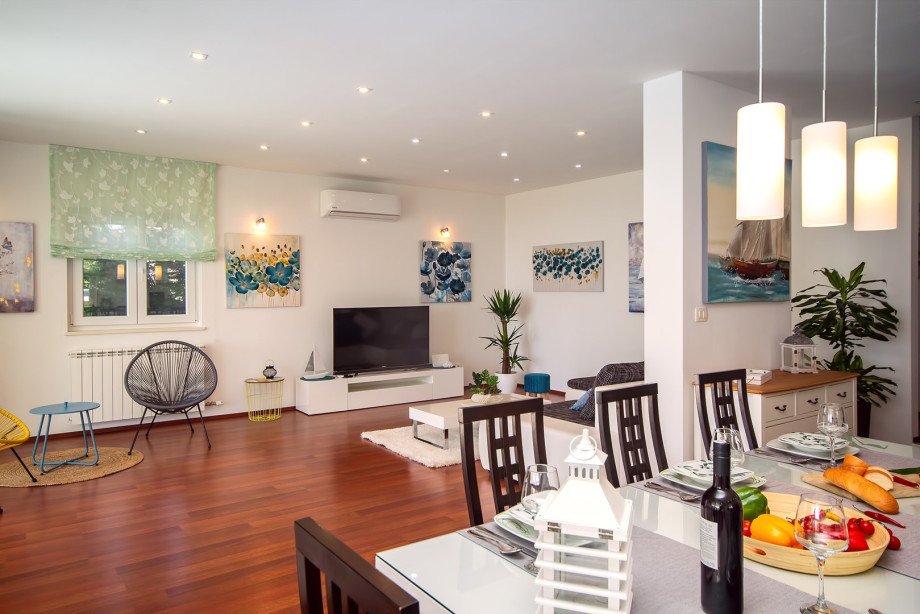 air-conditioned living and dining area with a fully equipped kitchen