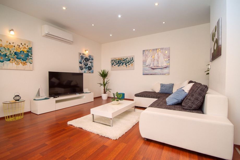 air-conditioned living and dining area with a fully equipped kitchen
