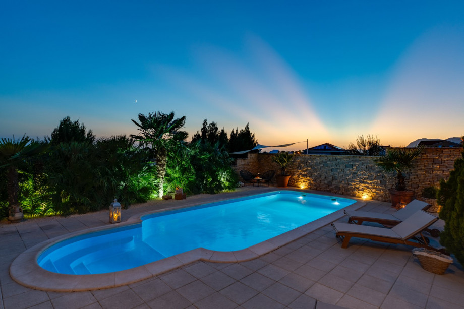 32 square meters pool, with 8 deck chairs at night