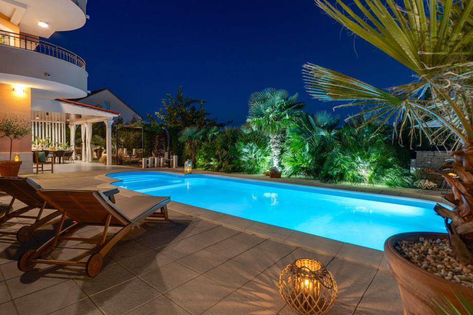 32 square meters pool, with 8 deck chairs at night