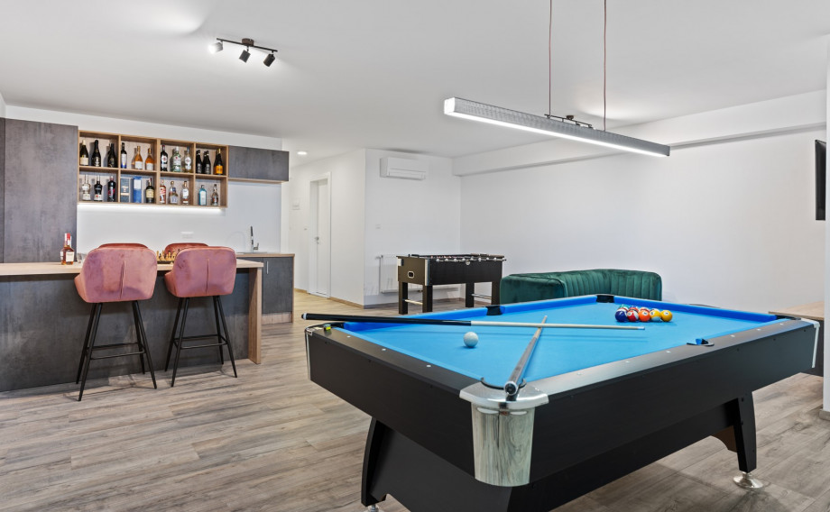 There is a well-organized fun area with a pool table, table soccer, darts