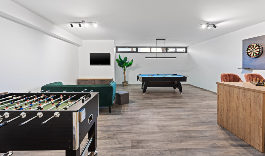 There is a well-organized fun area with a pool table, table soccer, darts