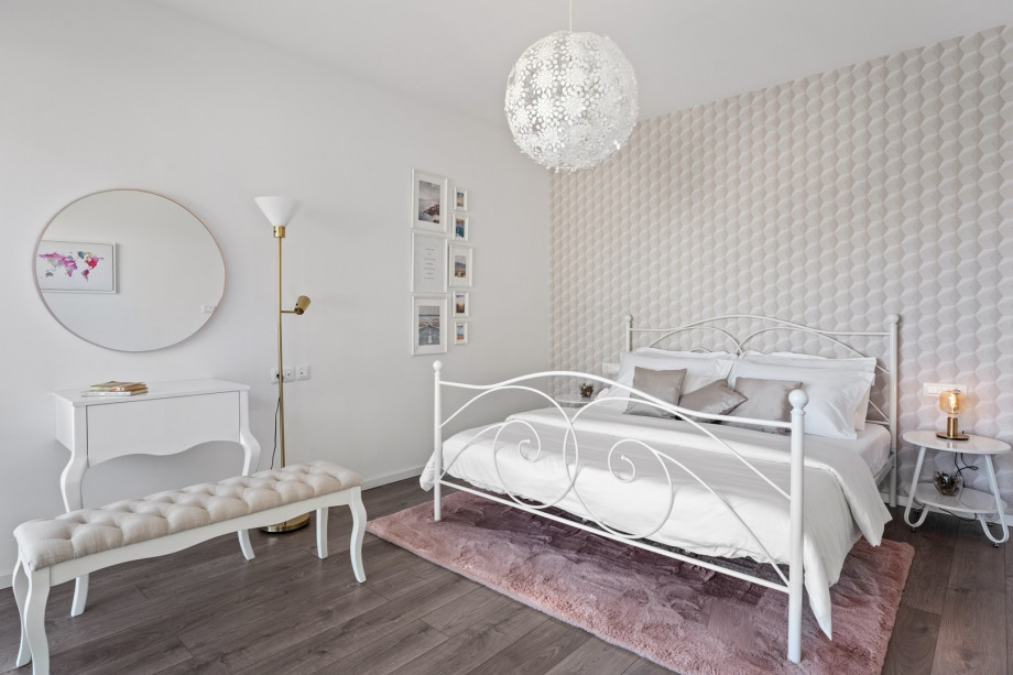 A balcony overlooking the pool and sea