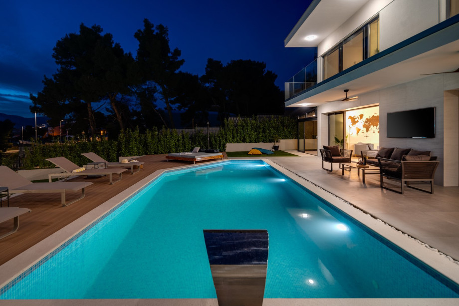 There are three distinct artificial grass grassplot areas in front of the pool area