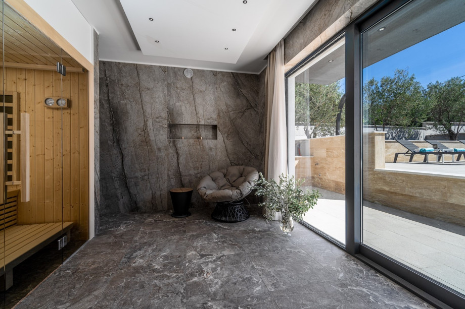 Finnish Sauna room with a shower and glass doors toward the pool area, a very pleasant 15 sqm room for your absolute relaxation