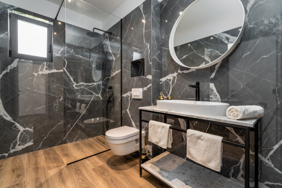 En-suite bathroom with a shower, air-conditioning, a balcony with sea views