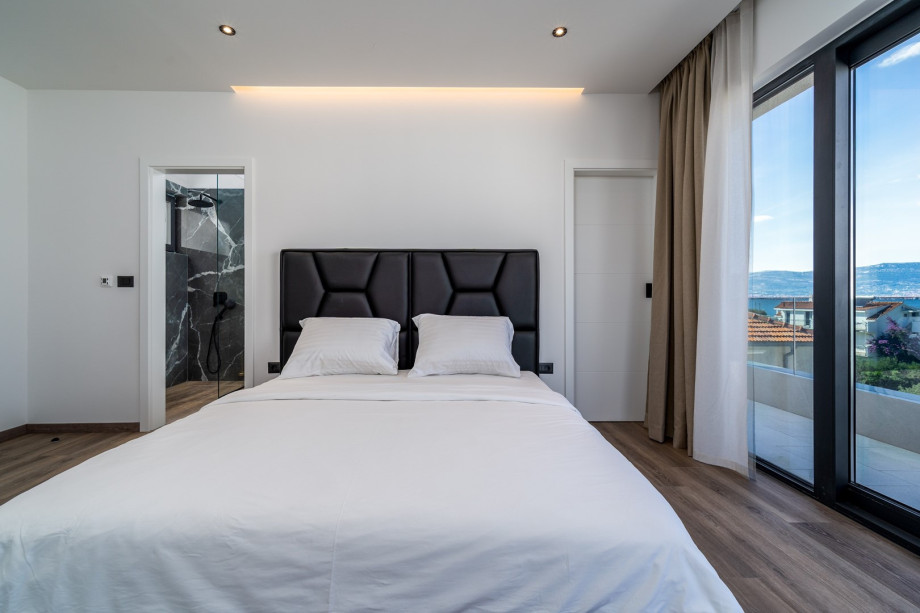 Bedroom No4 with king size bed 180cm x 200cm with a spacious balcony with opened sea views, en-suite bathroom with a shower, air-conditioned