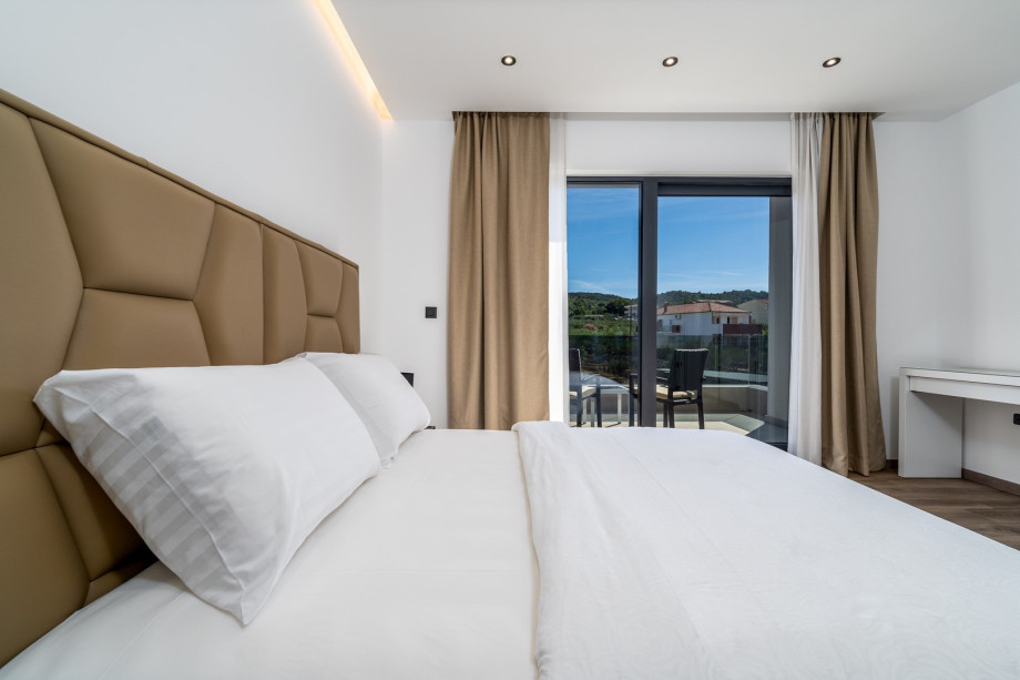 Bedroom No5 with king size bed 180cm x 200cm with a terrace overviewing the pool, en-suite bathroom with a shower, air-conditioning.