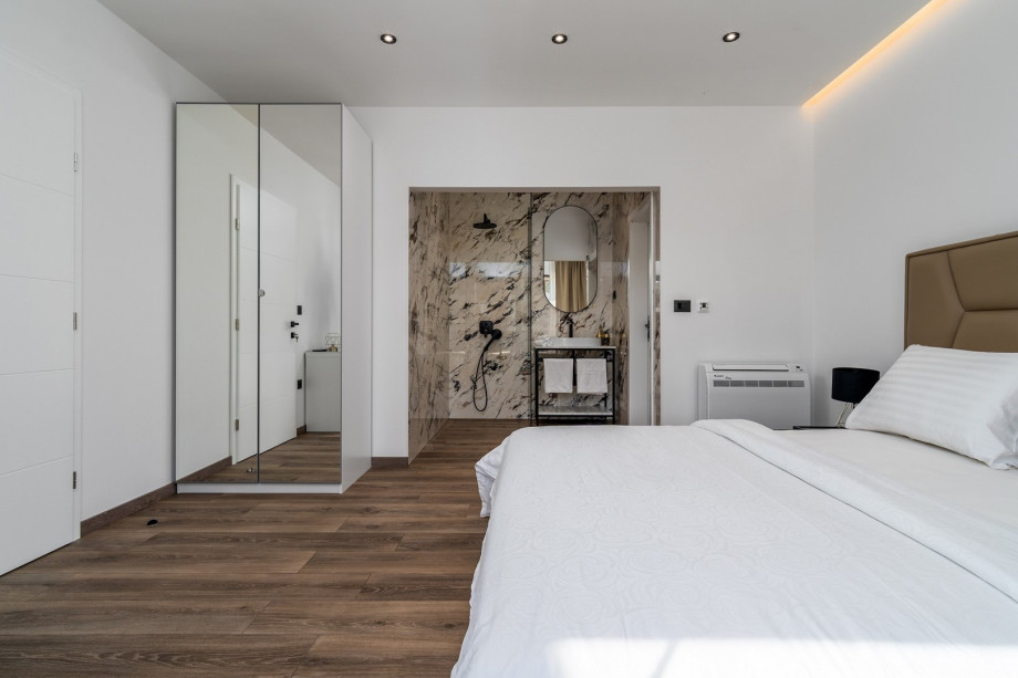 Bedroom No5 with king size bed 180cm x 200cm with a terrace overviewing the pool, en-suite bathroom with a shower, air-conditioning.