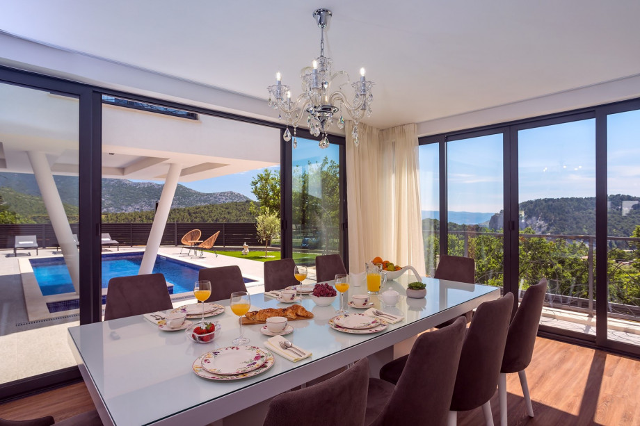 Dining area with a pool and mountain view